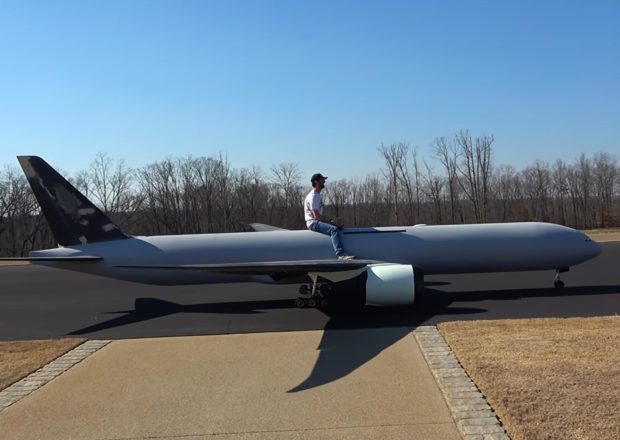a-man-sitting-on-a-large-remote-controlled-plane-2-620x440